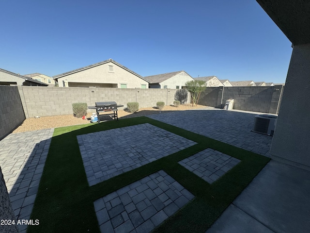 view of yard with a patio area and central air condition unit