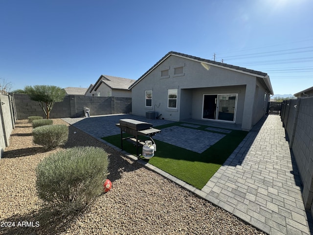 back of house with cooling unit and a patio area