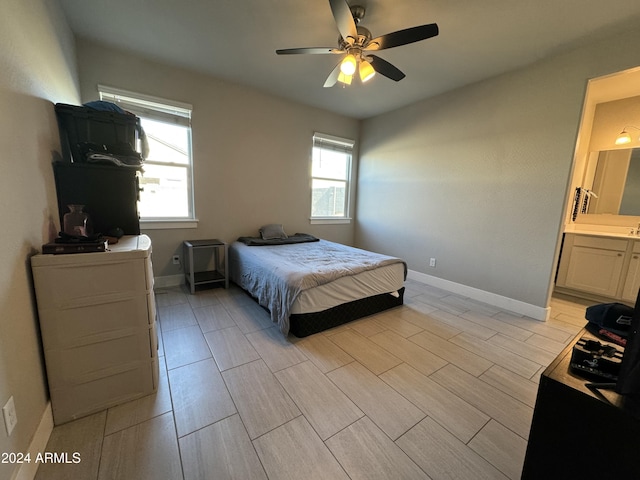 bedroom with ensuite bath and ceiling fan