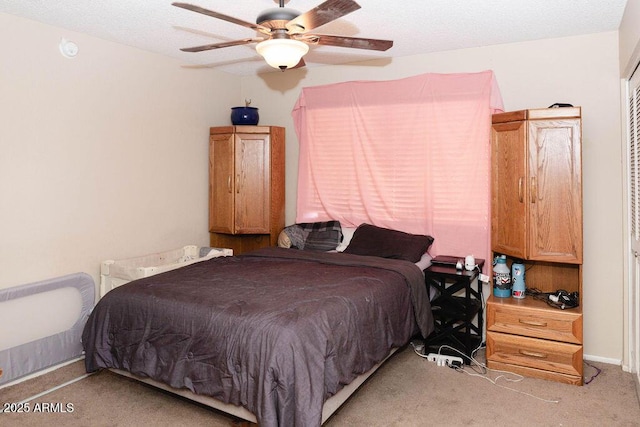 bedroom with a ceiling fan and light colored carpet