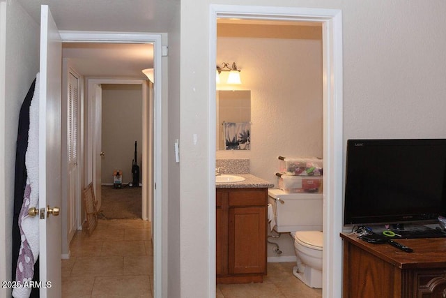 bathroom featuring vanity, toilet, and tile patterned floors