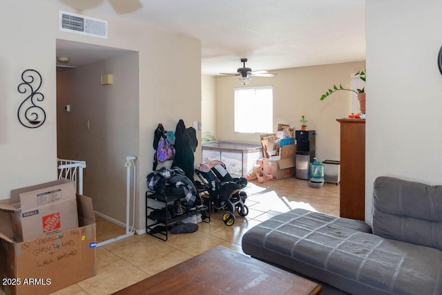 living room featuring a ceiling fan, visible vents, and tile patterned floors