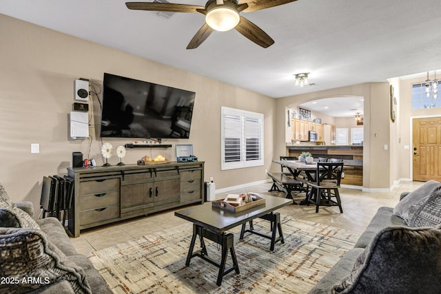 living room with light tile patterned floors and ceiling fan with notable chandelier