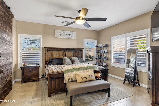 bedroom with ceiling fan and light tile patterned flooring