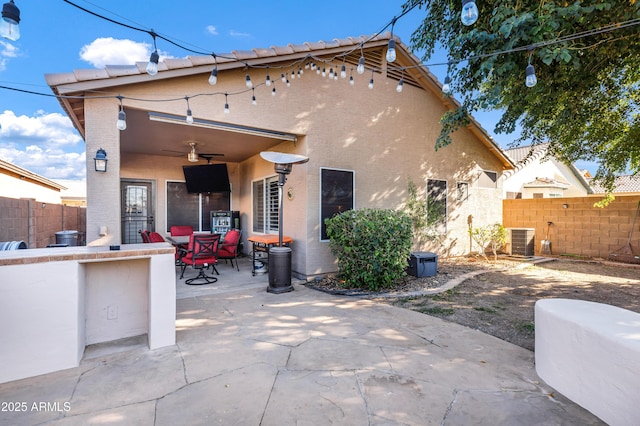 back of house featuring a patio area, ceiling fan, an outdoor bar, and central AC unit