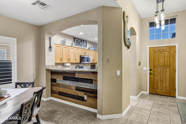 foyer entrance featuring light tile patterned floors