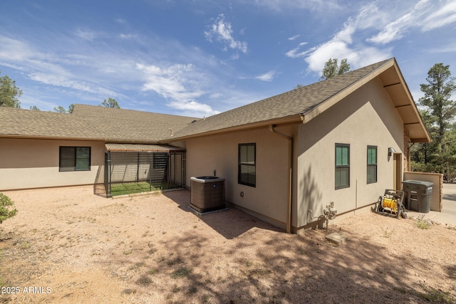 1002 W Rock Springs Cir, Payson, AZ 85541 - back of house with central air condition unit, stucco siding, and roof with shingles