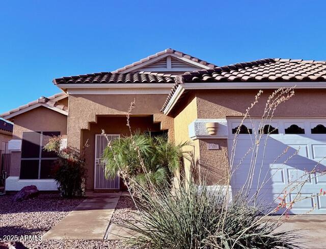 view of front of property with a tiled roof and stucco siding