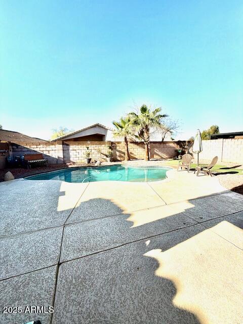 view of pool with a patio area, a fenced backyard, and a fenced in pool