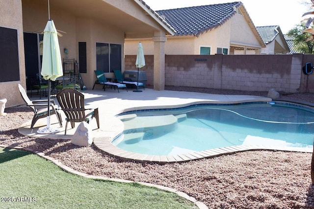 view of pool featuring a patio area, a fenced in pool, and a fenced backyard