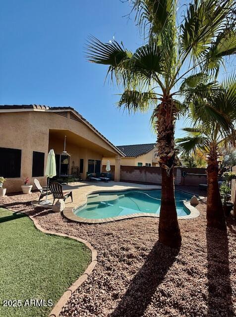 view of swimming pool with a patio area and a fenced in pool