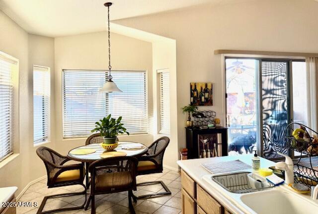 dining space featuring light tile patterned floors and baseboards