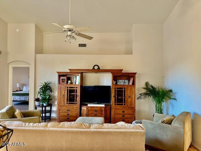 living room with visible vents and a ceiling fan