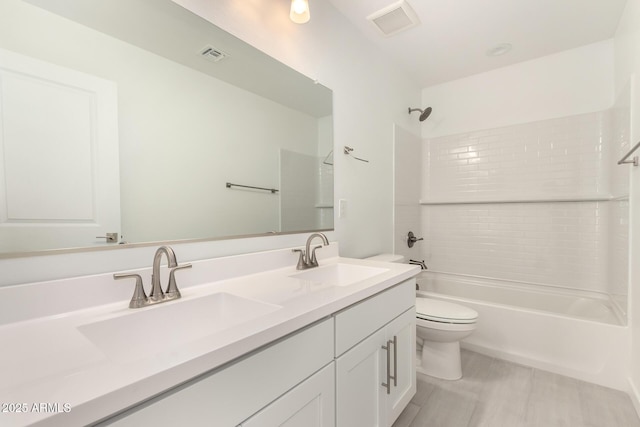 18189 W Hess St, Goodyear, AZ 85338 - bathroom featuring double vanity, bathing tub / shower combination, and toilet