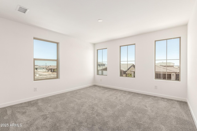 18189 W Hess St, Goodyear, AZ 85338 - empty room featuring healthy amount of natural light, carpet flooring, and baseboards