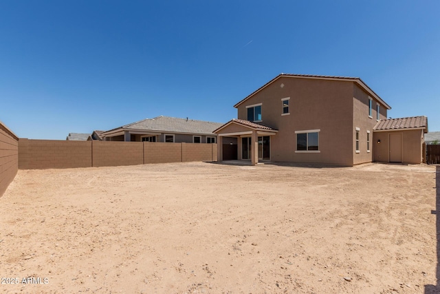 18189 W Hess St, Goodyear, AZ 85338 - rear view of house featuring a fenced backyard, stucco siding, a patio area, and a tile roof