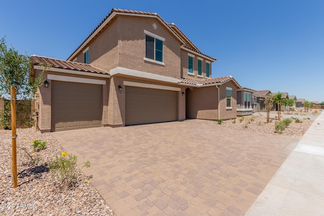 18189 W Hess St, Goodyear, AZ 85338 - view of front of property featuring a tile roof, stucco siding, and decorative driveway