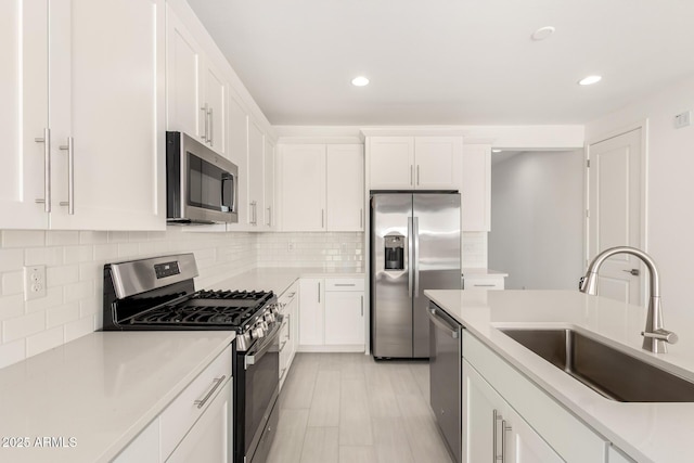 18189 W Hess St, Goodyear, AZ 85338 - kitchen featuring appliances with stainless steel finishes, a sink, recessed lighting, white cabinets, and light countertops