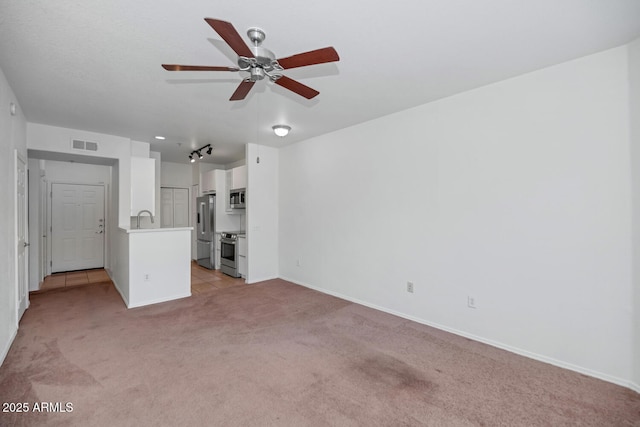 9820 N Central Ave Unit 303, Phoenix, AZ 85020 - unfurnished living room featuring light colored carpet, ceiling fan, a sink, and baseboards