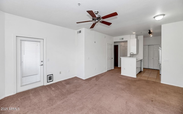 9820 N Central Ave Unit 303, Phoenix, AZ 85020 - unfurnished living room featuring light carpet, a sink, a ceiling fan, and baseboards