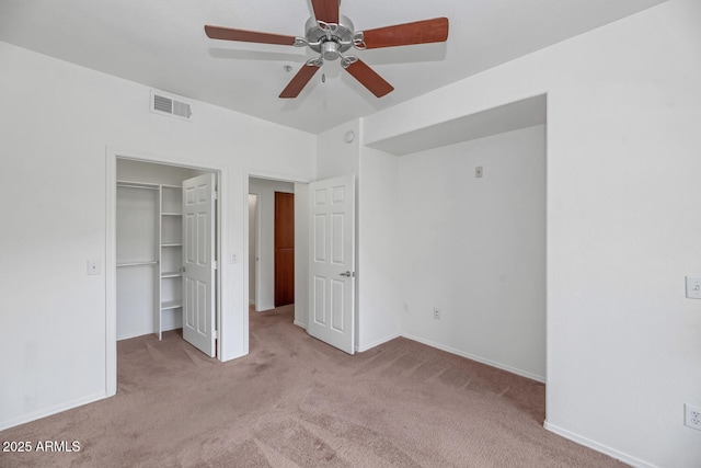9820 N Central Ave Unit 303, Phoenix, AZ 85020 - unfurnished bedroom featuring carpet flooring, a spacious closet, baseboards, a closet, and ceiling fan