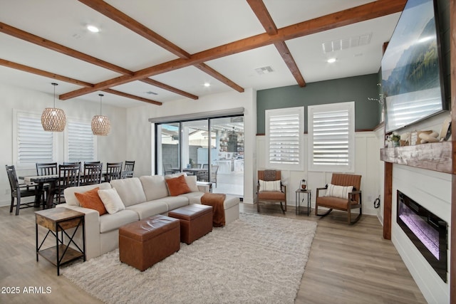 living room with coffered ceiling, beam ceiling, and light wood-type flooring