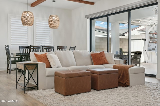 living room with light wood-type flooring and beamed ceiling