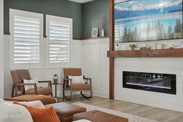 interior space featuring a large fireplace and light hardwood / wood-style floors