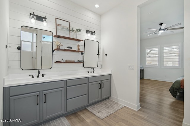 bathroom with hardwood / wood-style flooring, vanity, ceiling fan, and a healthy amount of sunlight