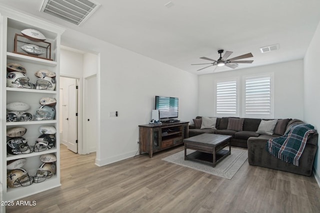 living room featuring ceiling fan and wood-type flooring