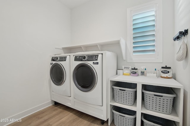 washroom with washer and dryer and wood-type flooring