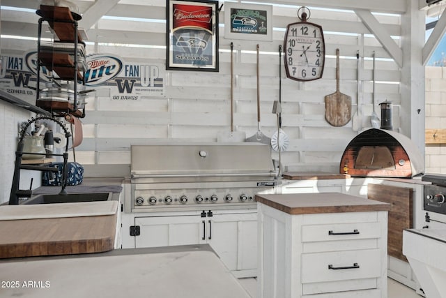 kitchen with white cabinets and wooden counters