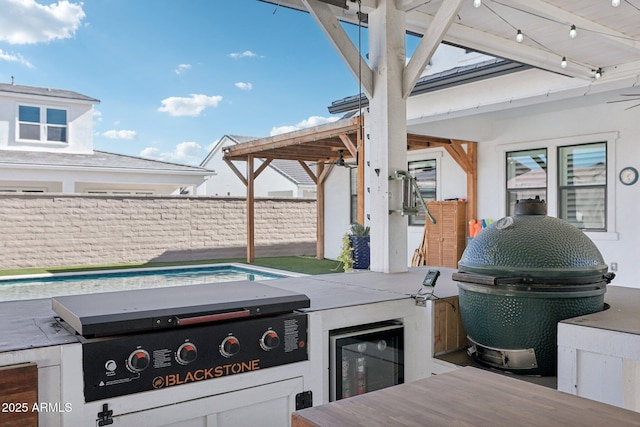 view of patio / terrace with area for grilling, a grill, and beverage cooler