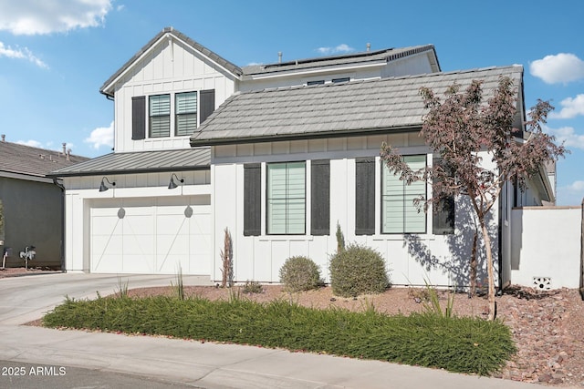 view of front of property featuring solar panels and a garage