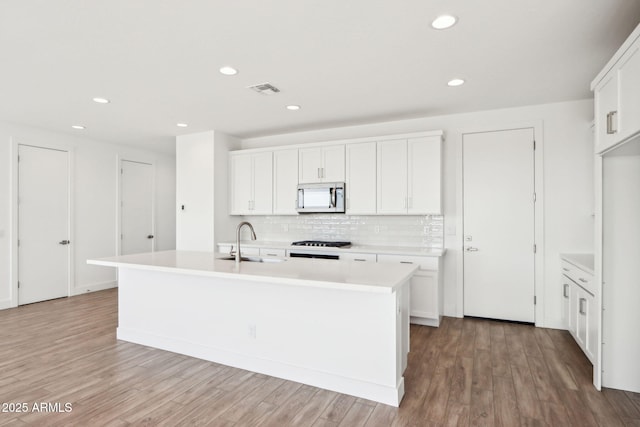 10241 E Ursula Ave, Mesa, AZ 85212 - kitchen featuring a sink, tasteful backsplash, a kitchen island with sink, light countertops, and recessed lighting