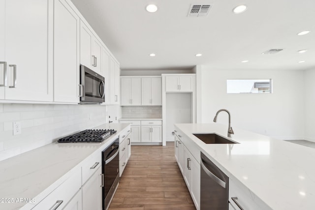 10241 E Ursula Ave, Mesa, AZ 85212 - kitchen featuring appliances with stainless steel finishes, a sink, recessed lighting, light wood-style floors, and white cabinetry