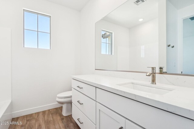 10241 E Ursula Ave, Mesa, AZ 85212 - full bath featuring vanity, toilet, wood finished floors, baseboards, and a tub
