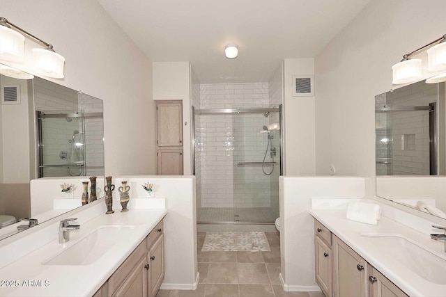 bathroom featuring toilet, an enclosed shower, tile patterned floors, and vanity