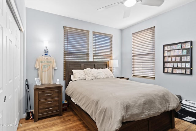 bedroom with ceiling fan, a closet, and light hardwood / wood-style floors