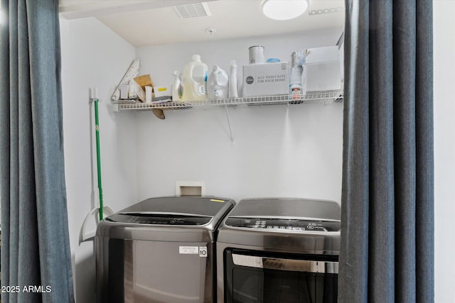 clothes washing area with washer and clothes dryer