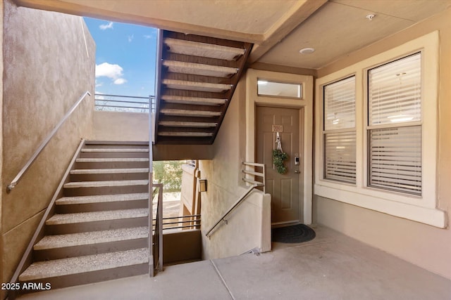 view of exterior entry with a balcony