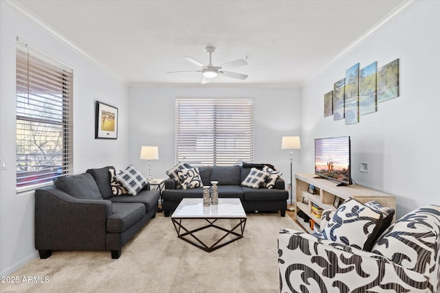 living room with ceiling fan, light colored carpet, and ornamental molding