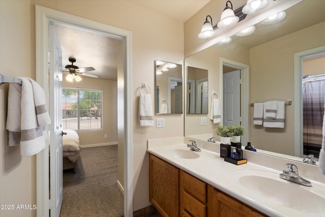 3658 E Pony Track Ln, San Tan Valley, AZ 85140 - full bathroom with double vanity, ensuite bath, ceiling fan, and baseboards