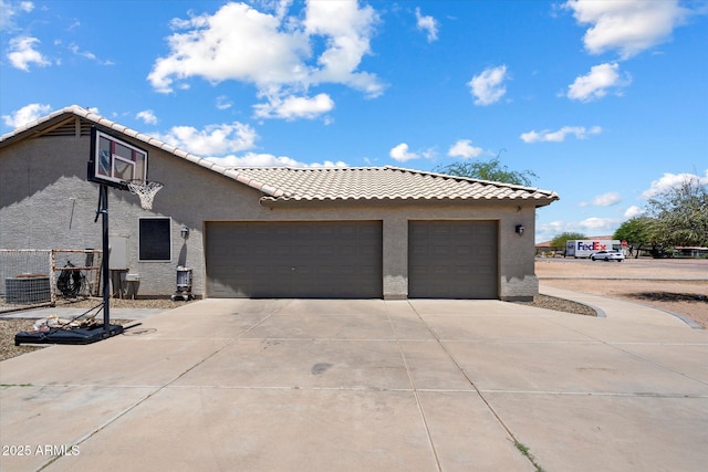 3658 E Pony Track Ln, San Tan Valley, AZ 85140 - view of property exterior featuring concrete driveway, stucco siding, a tile roof, and an attached garage