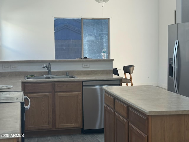 kitchen featuring a kitchen island, sink, and appliances with stainless steel finishes