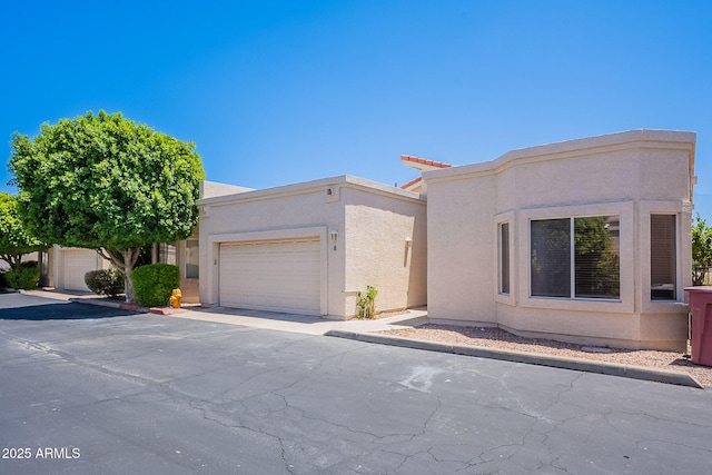 2647 N Miller Rd Unit 6, Scottsdale, AZ 85257 - view of front facade with stucco siding and an attached garage