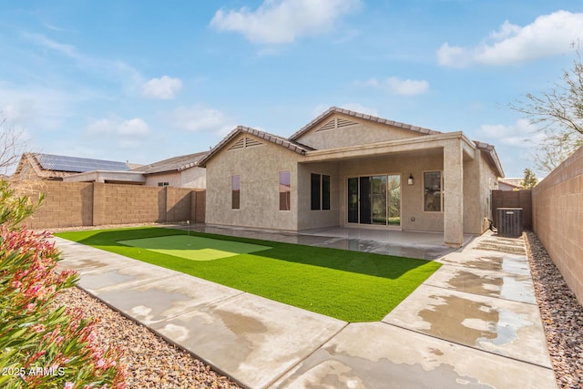 5590 W Victory Way, Florence, AZ 85132 - rear view of house with a putting green, a fenced backyard, a patio area, cooling unit, and stucco siding