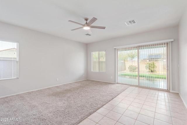 5590 W Victory Way, Florence, AZ 85132 - empty room featuring a ceiling fan, light tile patterned floors, baseboards, and light colored carpet