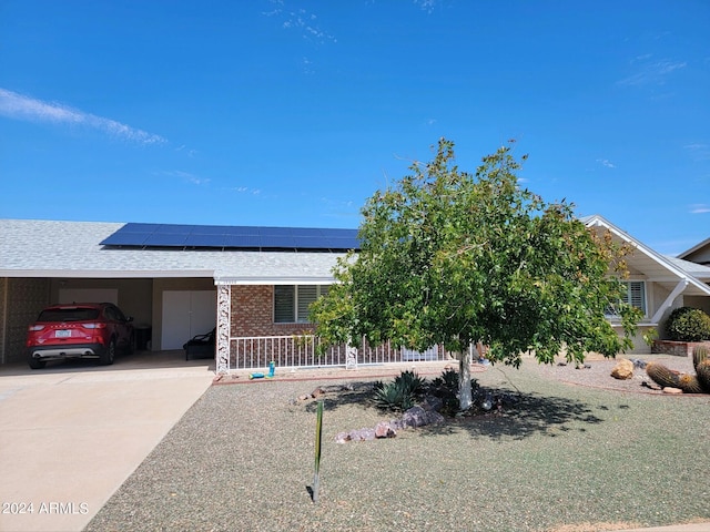 view of front of home featuring a carport and solar panels