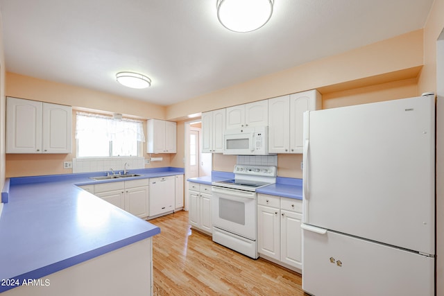 kitchen with light wood-type flooring, white appliances, white cabinetry, and tasteful backsplash